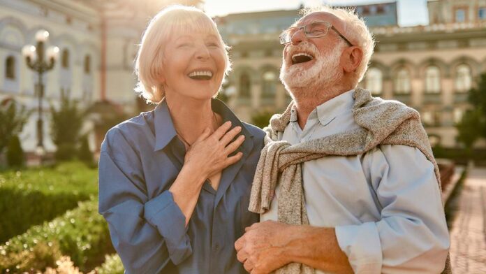 You Make Me Happy! Portrait of beautiful and stylish senior laughing while standing in the park together on a sunny day